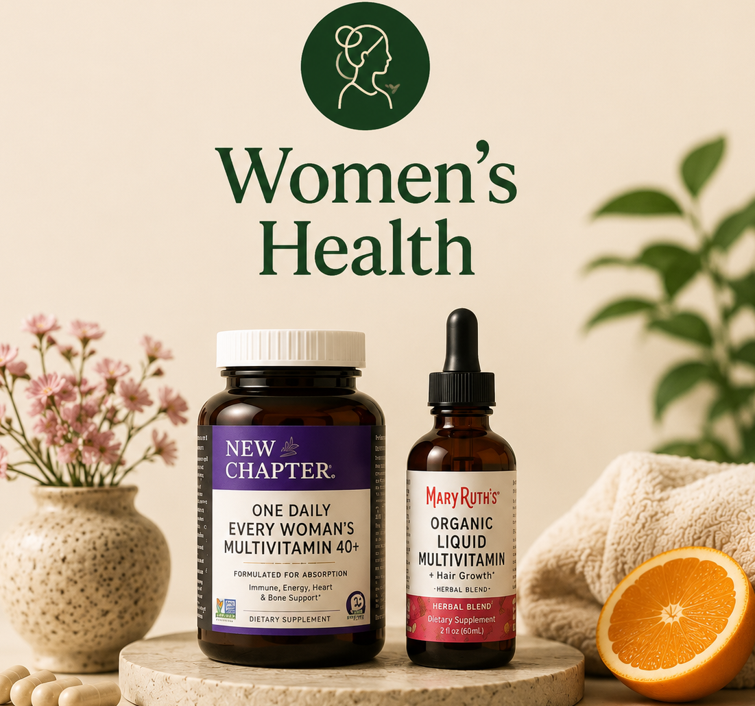 Two supplement products displayed on a stone pedestal with a beige background and decorative props including flowers, a towel, and an orange slice. Visible products are a dark brown bottle labeled New Chapter One Daily Every Woman's Multivitamin 40+ and an amber dropper bottle labeled Mary Ritter Organic Liquid Multivitamin.